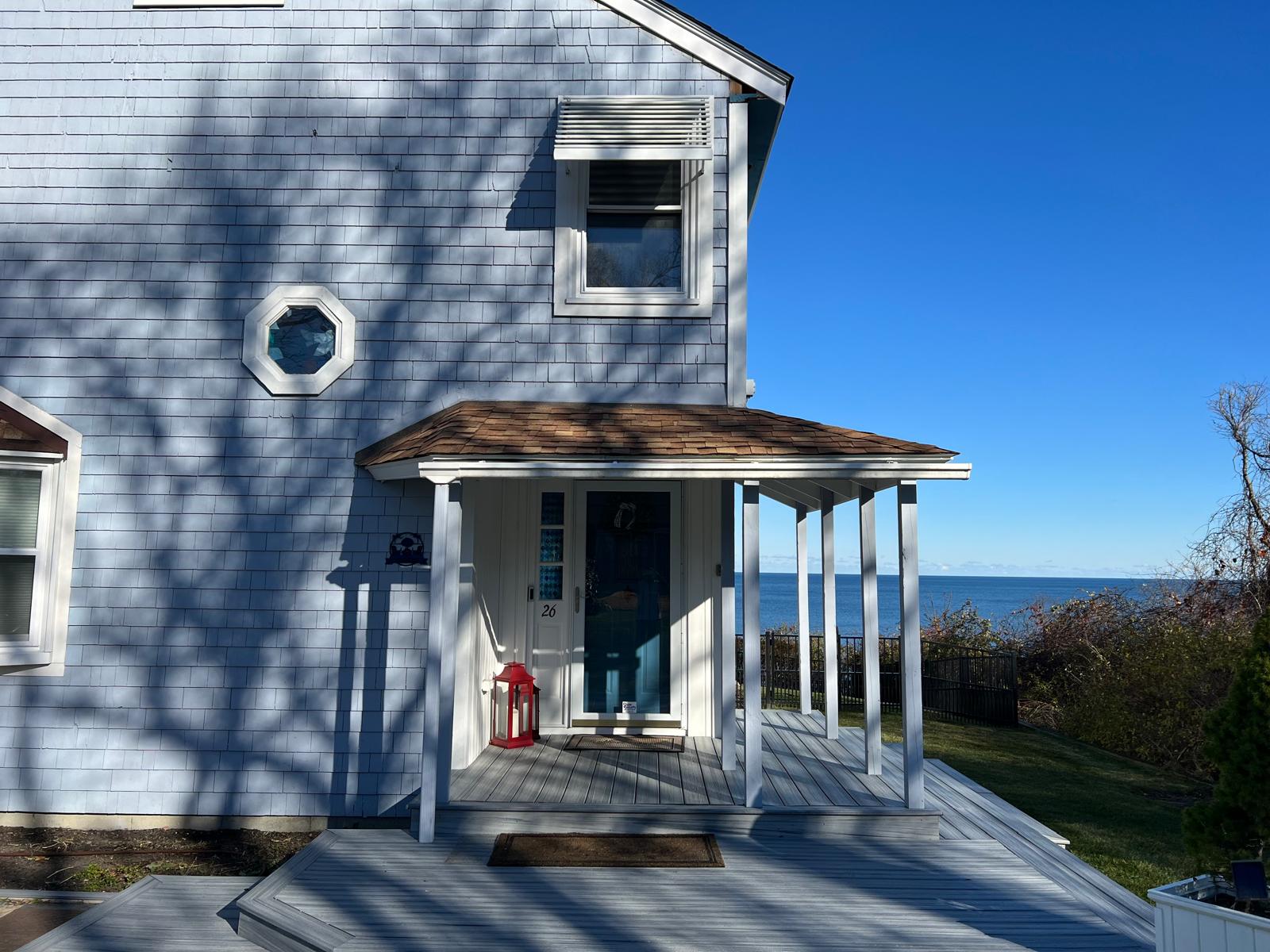 a house with a porch (vinyl siding and deck)