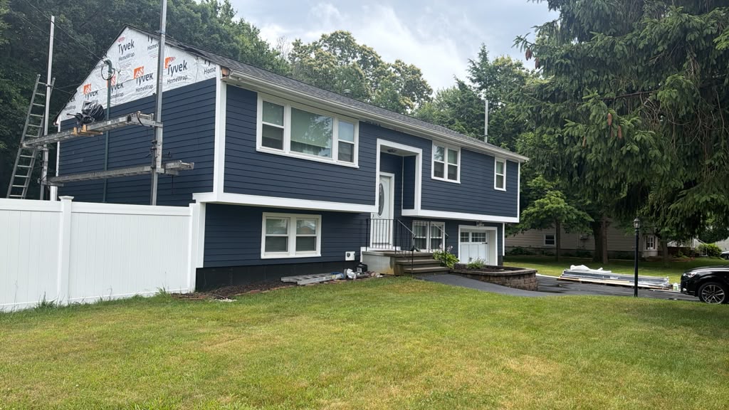 Multi-service exterior renovation Massachusetts home with roofing, siding, windows, gutters, and deck updates