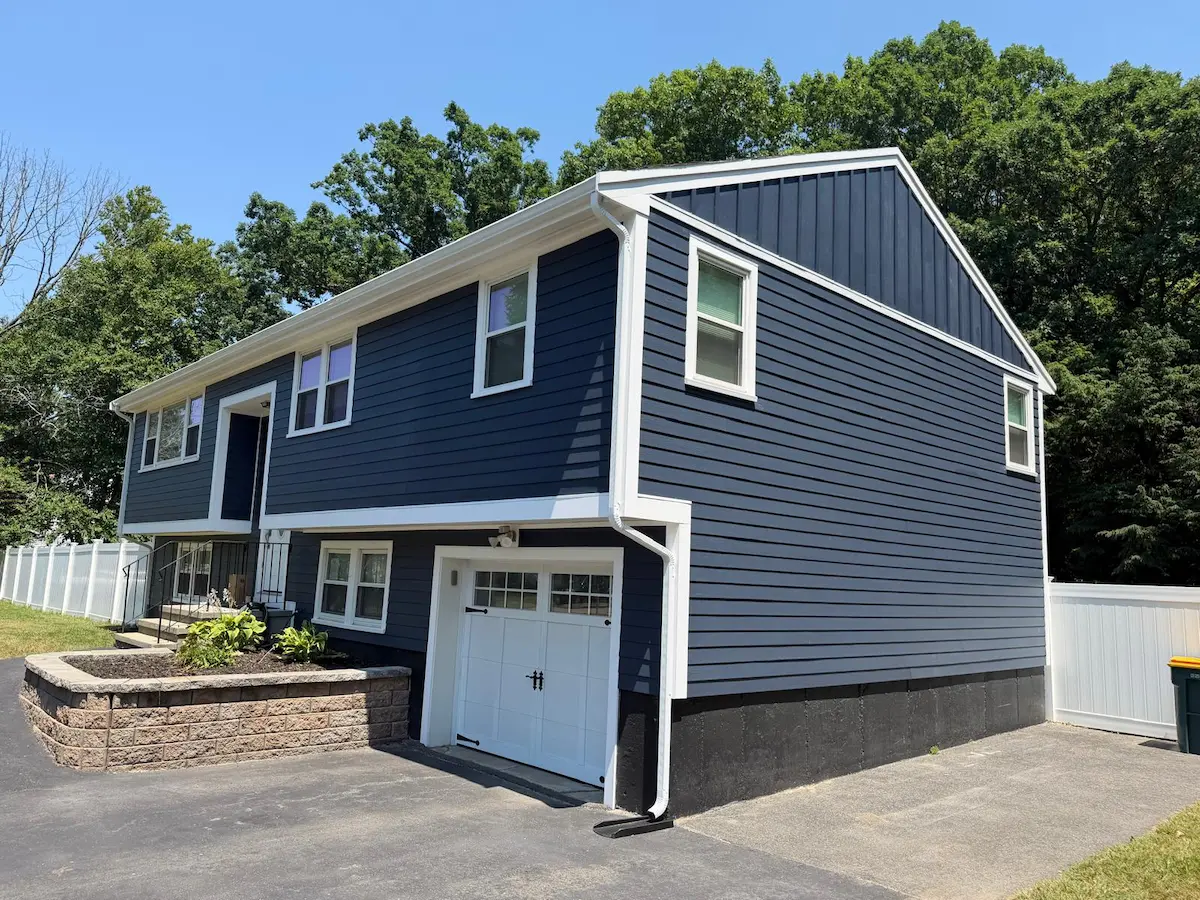 Rear of Abington home with new blue HardiePlank siding and white deck