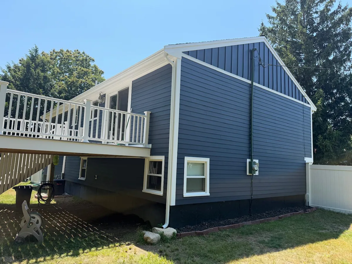 Rear of Abington home with new blue HardiePlank siding and white deck