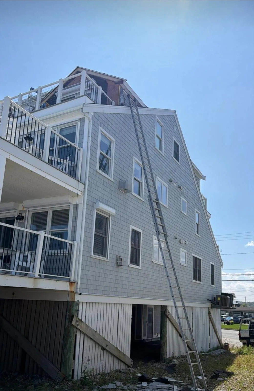 Siding removed from the upper front and side walls during exterior repairs in Marshfield MA